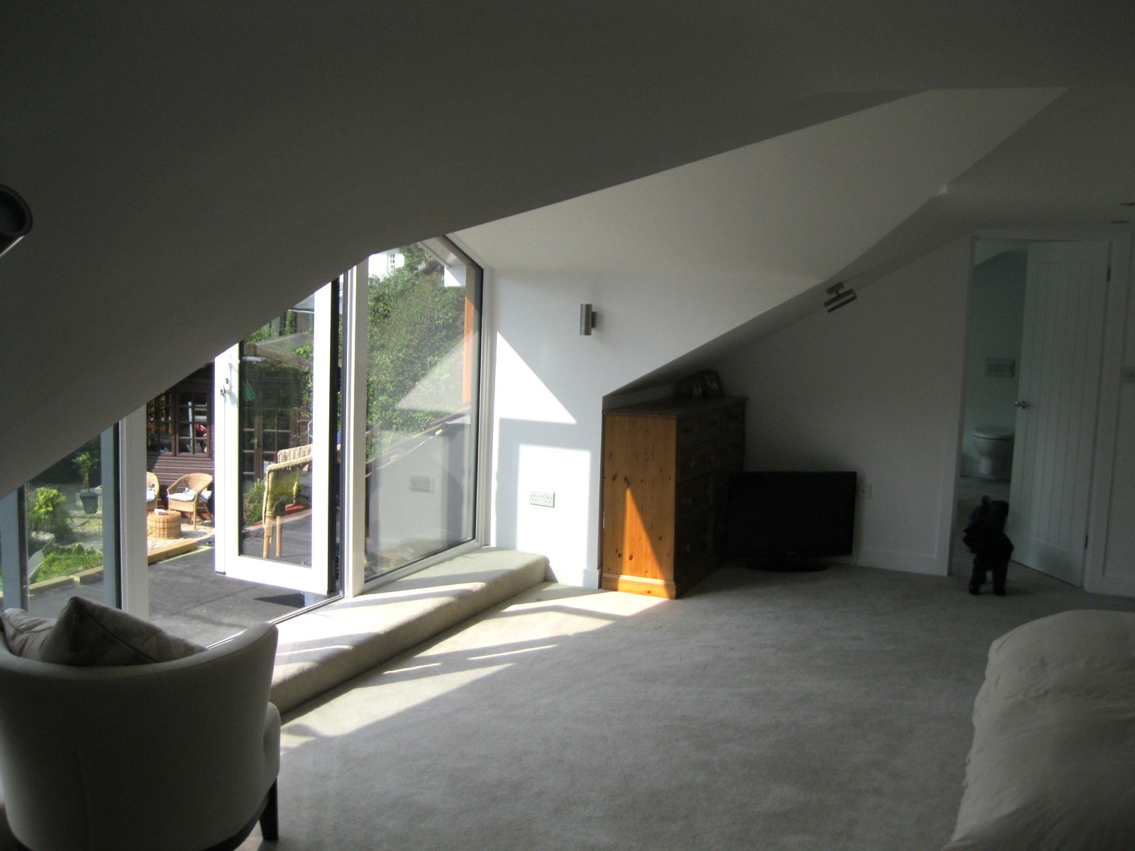 Loft conversion interior with large dormer window