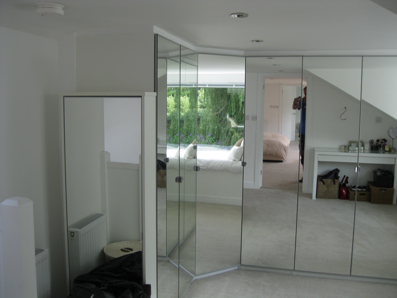 Floor-to-ceiling mirrored wardrobes in loft conversion
