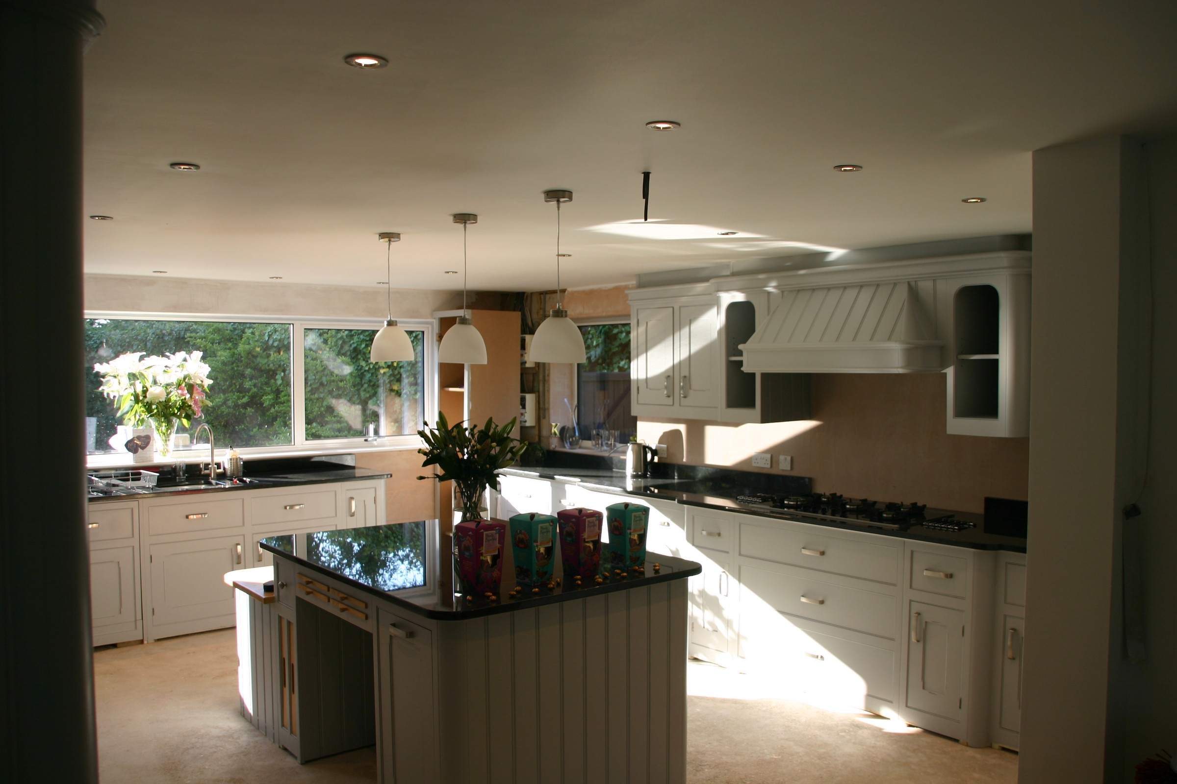 Bespoke fitted kitchen with painted cabinets and granite island by RMJ Carpentry